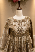 Ivory gold Pakistani bridal peshwas lehenga front view with intricate embroidery

