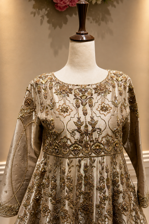 Ivory gold Pakistani bridal peshwas lehenga front view with intricate embroidery

