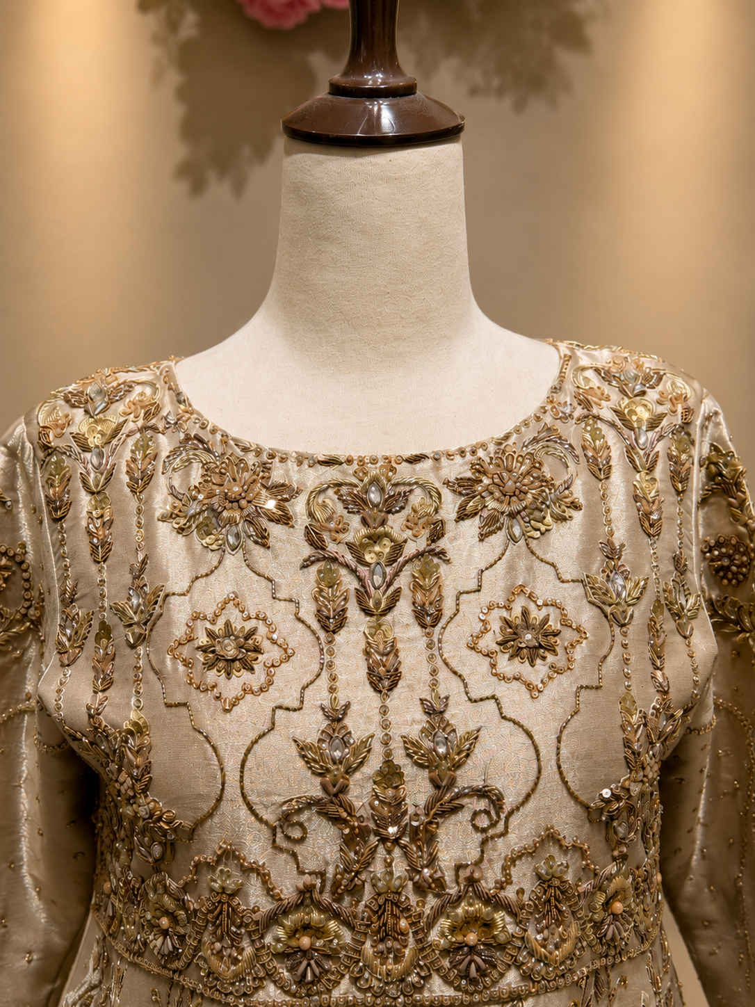 Detailed view of gold embroidered ivory bridal peshwas dress

